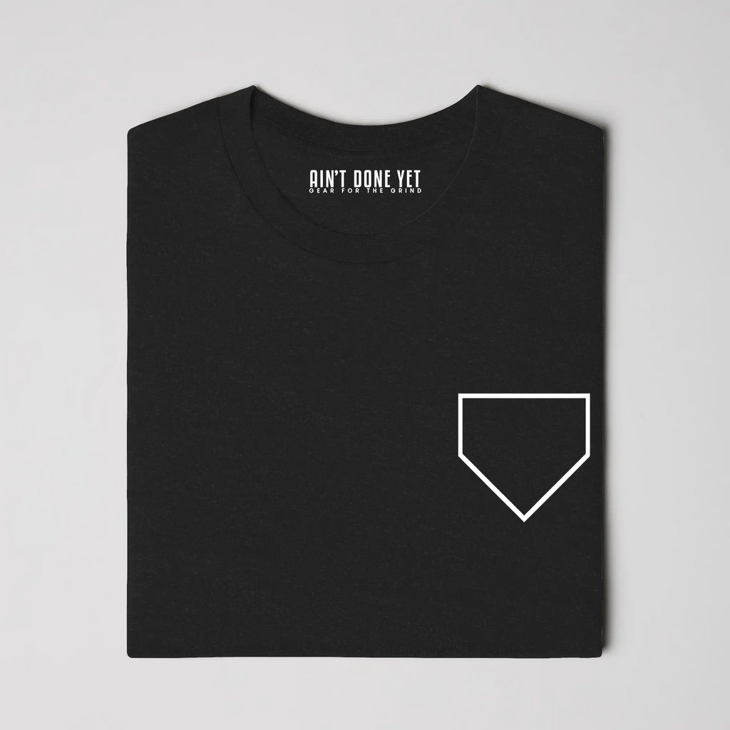 Middle Middle Tee with home plate graphic on front and baseball seam design with Ain’t Done Yet branding on back
