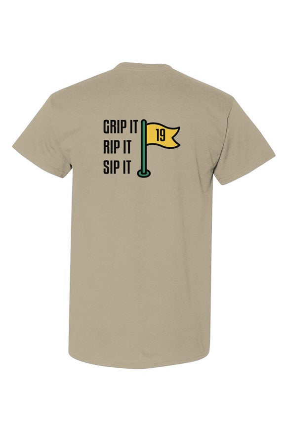 Sand colored Grip Rip Sip Tee with Ain’t Done Yet golf logo on chest and Grip It Rip It Sip It flag graphic on back
