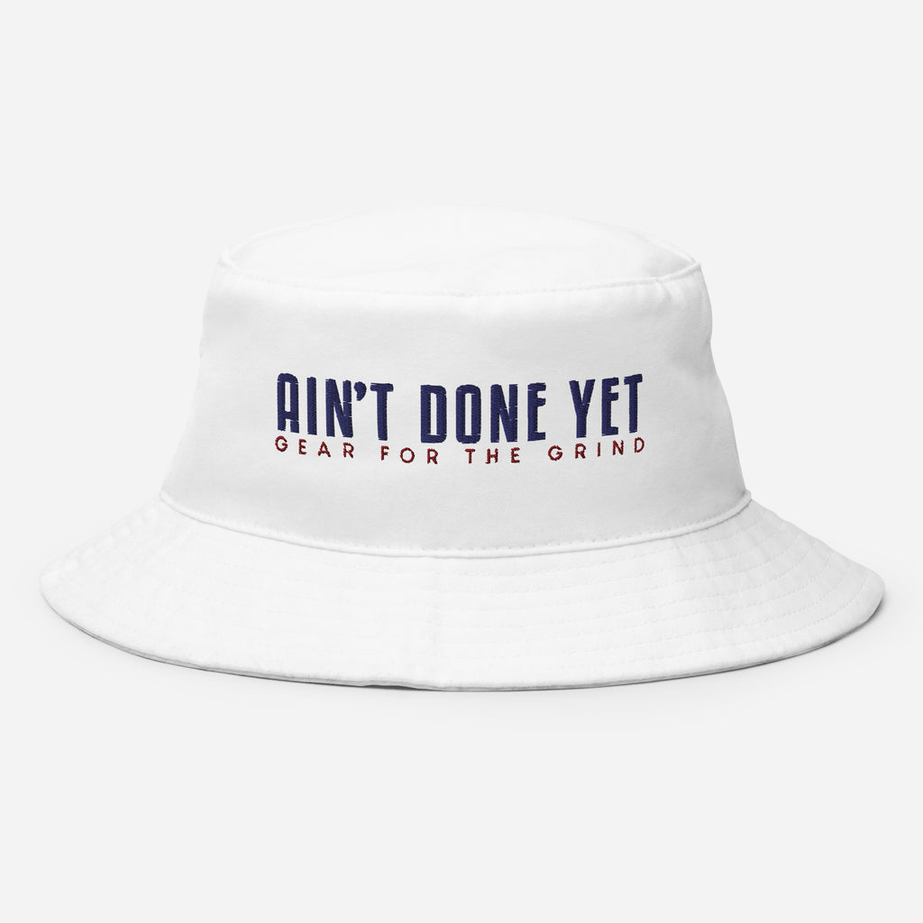 The Freedom Bucket hat in white featuring embroidered Ain't Done Yet logo and Gear For The Grind tagline in patriotic colors.