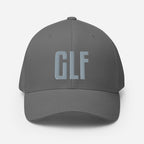 Flex-fit golf hat featuring Play Code GLF front embroidery with structured six-panel design and silver undervisor
