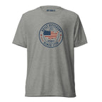 Built Different America 250 athletic grey tri-blend t-shirt featuring patriotic circular emblem with American flag and 1776 design.