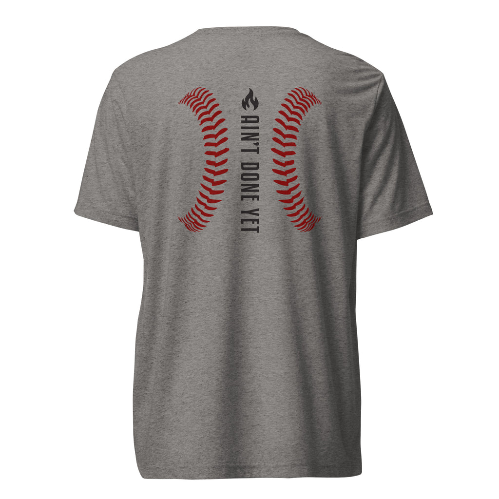 Ain’t Done Yet Middle Middle baseball tee featuring home plate graphic and baseball seam design on a lightweight tri-blend shirt.