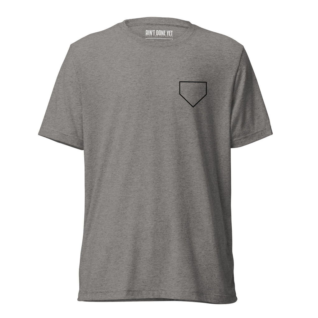Ain’t Done Yet Middle Middle baseball tee featuring home plate graphic and baseball seam design on a lightweight tri-blend shirt.